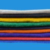 Stack of Different Color Towels on Blue Background