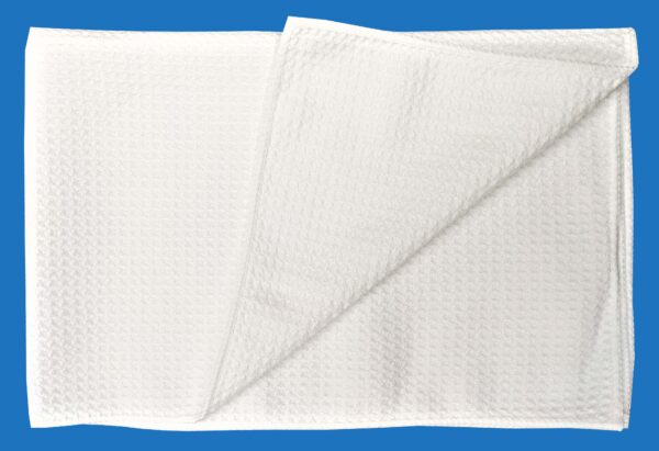 A White Folded and Textured Towel on Blue Background