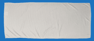 A White Color Towel Laid on a Blue Background